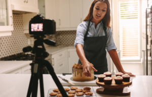 Young woman filming while baking.