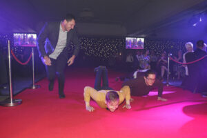 Deaf Action members performing 'the worm' up the red carpet at the National Youth Work Awards 2023